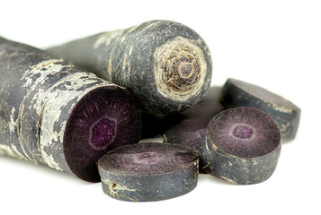 Cut up purple carrots isolated on white background texture
