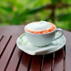 Cup of coffee on a wooden table