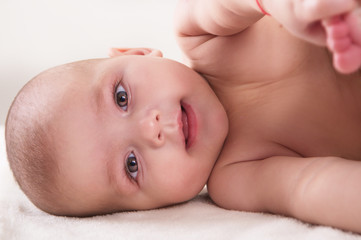 the infant baby lying on its side