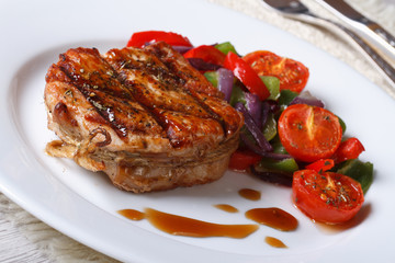 Beautiful pork steak with vegetables close-up, horizontal