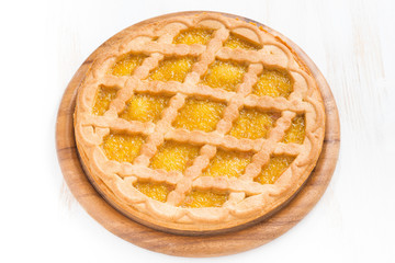 pie with fruit filling on a white wooden background