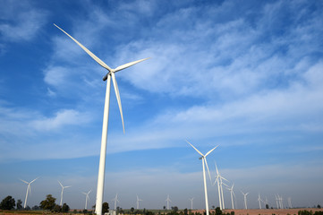 wind turbine against cloudy blue sky background
