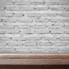 Wooden empty table with brick wall