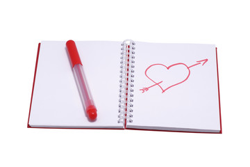 Figure heart in a notebook and a red felt-tip pen.