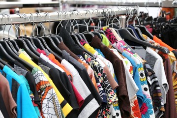 vintage clothes of many colors for sale at flea market