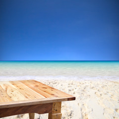 Wood table on blurred beach background