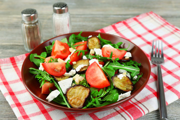 Eggplant salad with tomatoes, arugula and feta cheese,