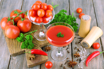 Tomato juice in goblet and fresh vegetables