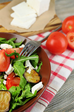 Eggplant salad with tomatoes, arugula and feta cheese,