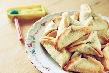 top view of Hamantaschen cookies or hamans ears and noisemaker f