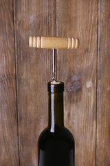 Bottle opener close-up, on wooden background