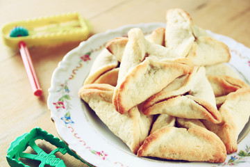top view of Hamantaschen cookies or hamans ears and noisemaker f