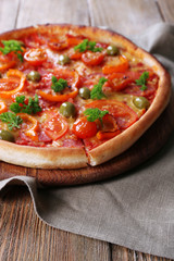 Tasty pizza with sausage and vegetables