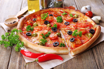 Tasty pizza with sausage, vegetables and chili pepper