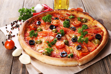 Tasty pizza with sausage, vegetables and chili pepper