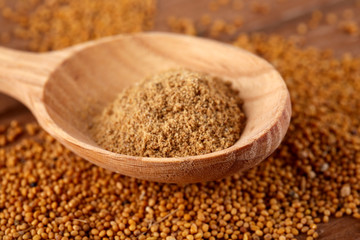 Mustard powder in wooden spoon