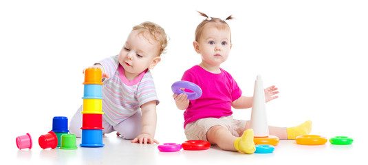 Adorable kids playing with colorful towers isolated