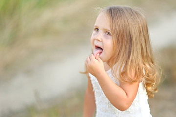 Fototapeta premium portrait of little girl outdoors in summer