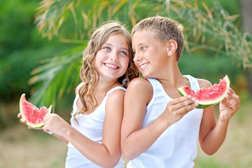 Fototapeta premium Portrait of a boy and girl on the beach in summer