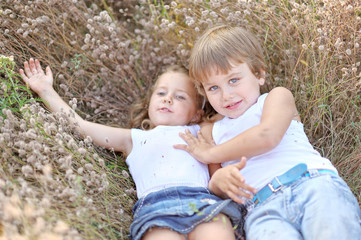 Portrait of a boy and girl on the field in summer