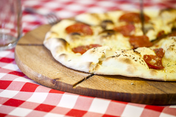 Delicious Italian pizza served on wooden board.