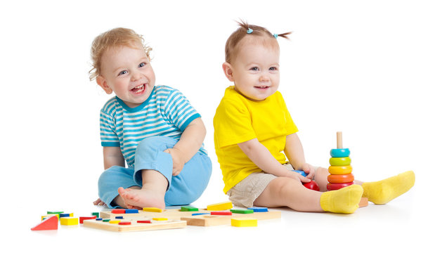 Adorable kids playing educational toys isolated