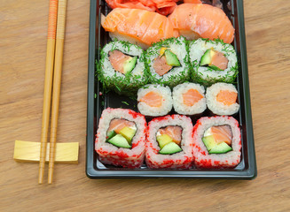 Japanese sushi and rolls close up on wooden background