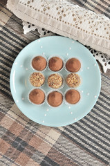 Nine round vegetarian candies on blue plate