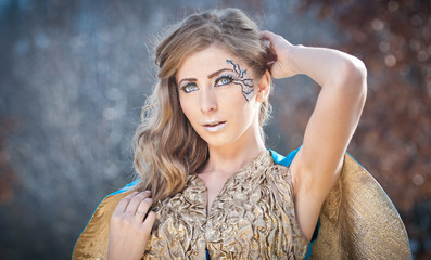 Naklejka premium Lovely young lady in elegant dress posing winter scenery