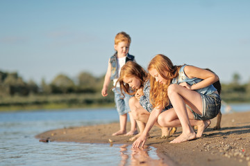 Fototapeta premium Portrait of a boy and his two sisters loved