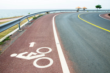 Bicycle route sign on the road by the sea