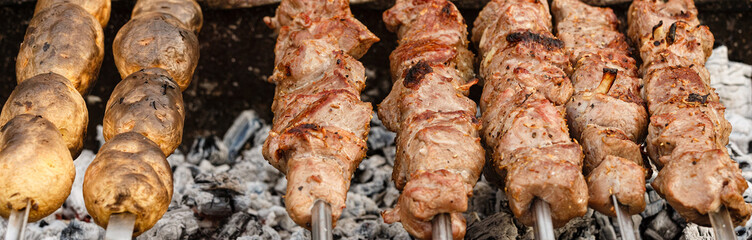 Meat and potato on a grill