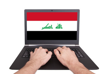 Hands working on laptop, Iraq