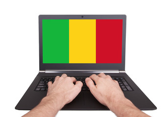 Hands working on laptop, Mali