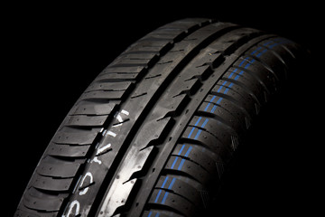 Car tires close-up on black background