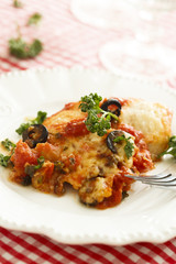 Baked fish with olives, herbs and tomatoes