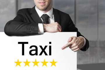 businessman pointing on sign taxi