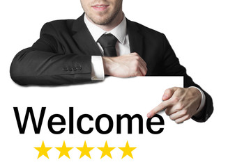 businessman pointing on sign welcome