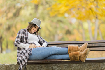 Fototapeta premium Young pregnant woman in the autumn park