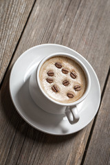 White coffee cup on wooden table.