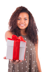 Beautiful young woman holding a gift over a white background.