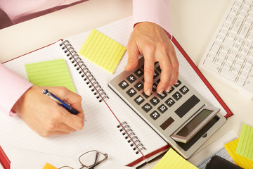 Businesswoman working with calculator