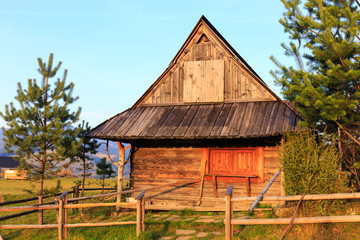 Shepherd wooden hut on meadow in autumn season