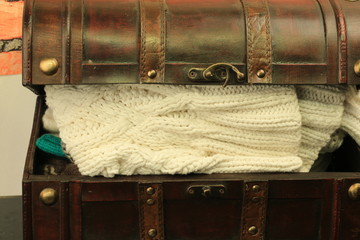 old trunk with a  knitted clothes things