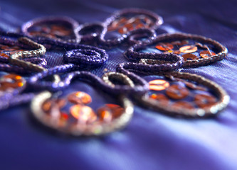 Handmade embroidery with sequins on a purple pillow