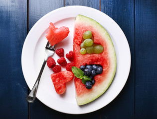 Fresh juicy watermelon slice  with cut out heart shape, filled