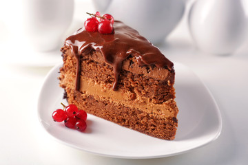 Delicious chocolate cake on plate on table on light background