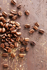 Coffee beans on wooden background, close-up