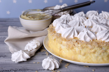 Tasty homemade meringue cake on wooden table