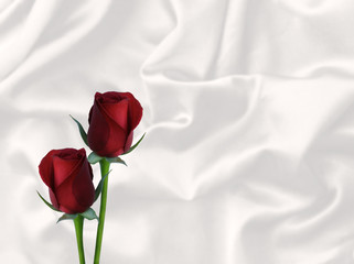 two red roses and white satin valentine's background